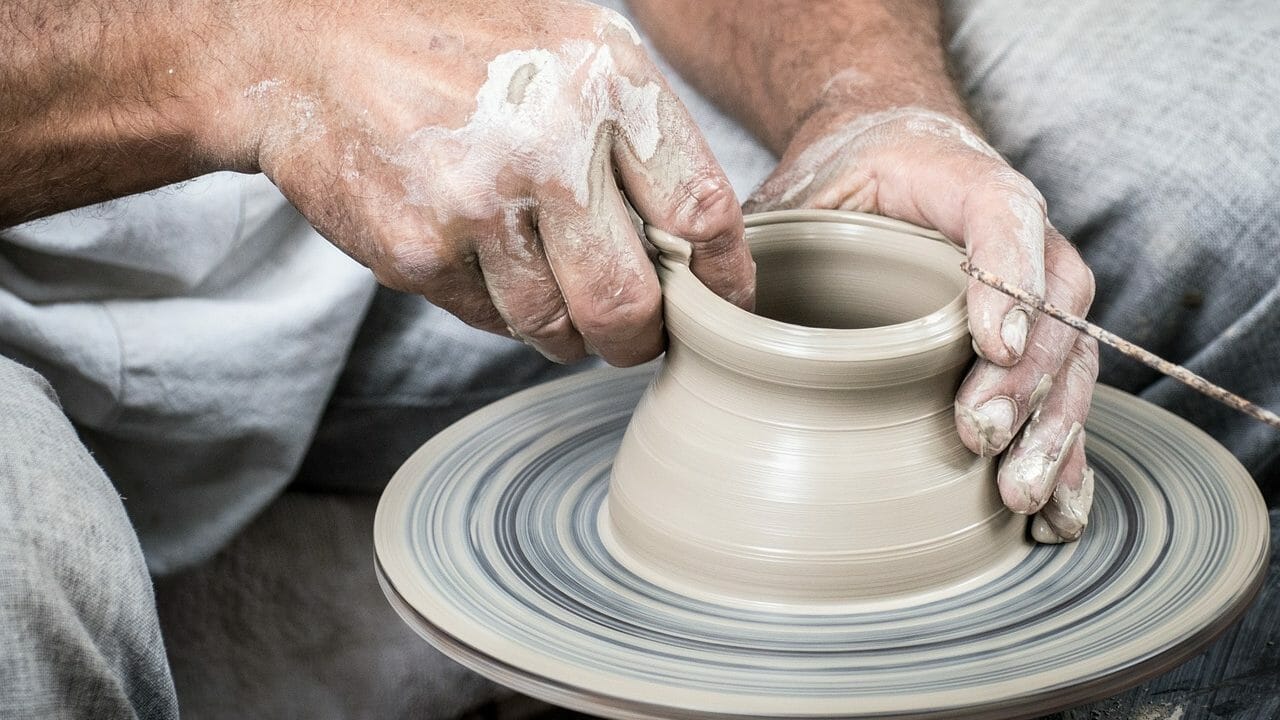 Potter throwing clay