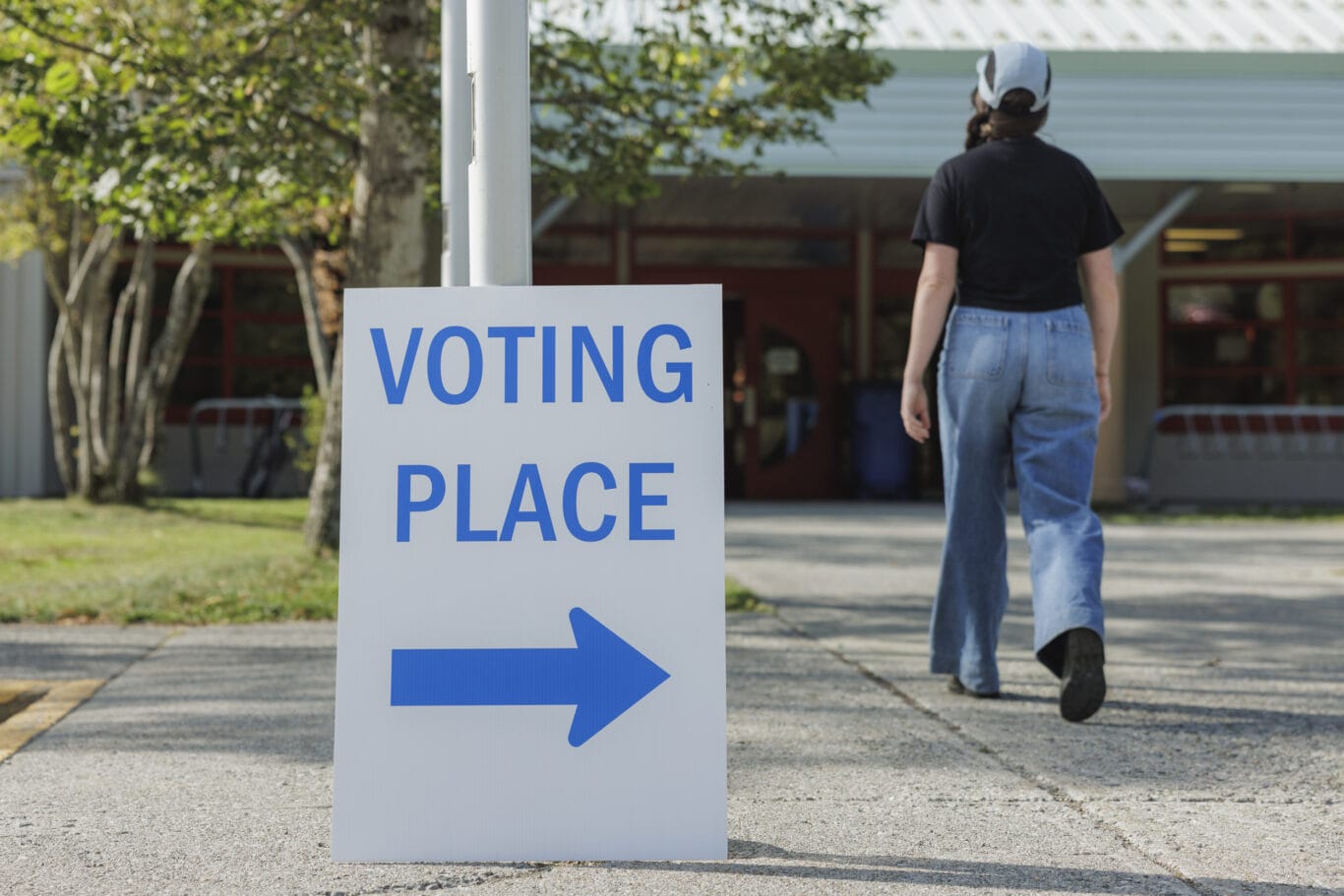 Woman walking into building to vote