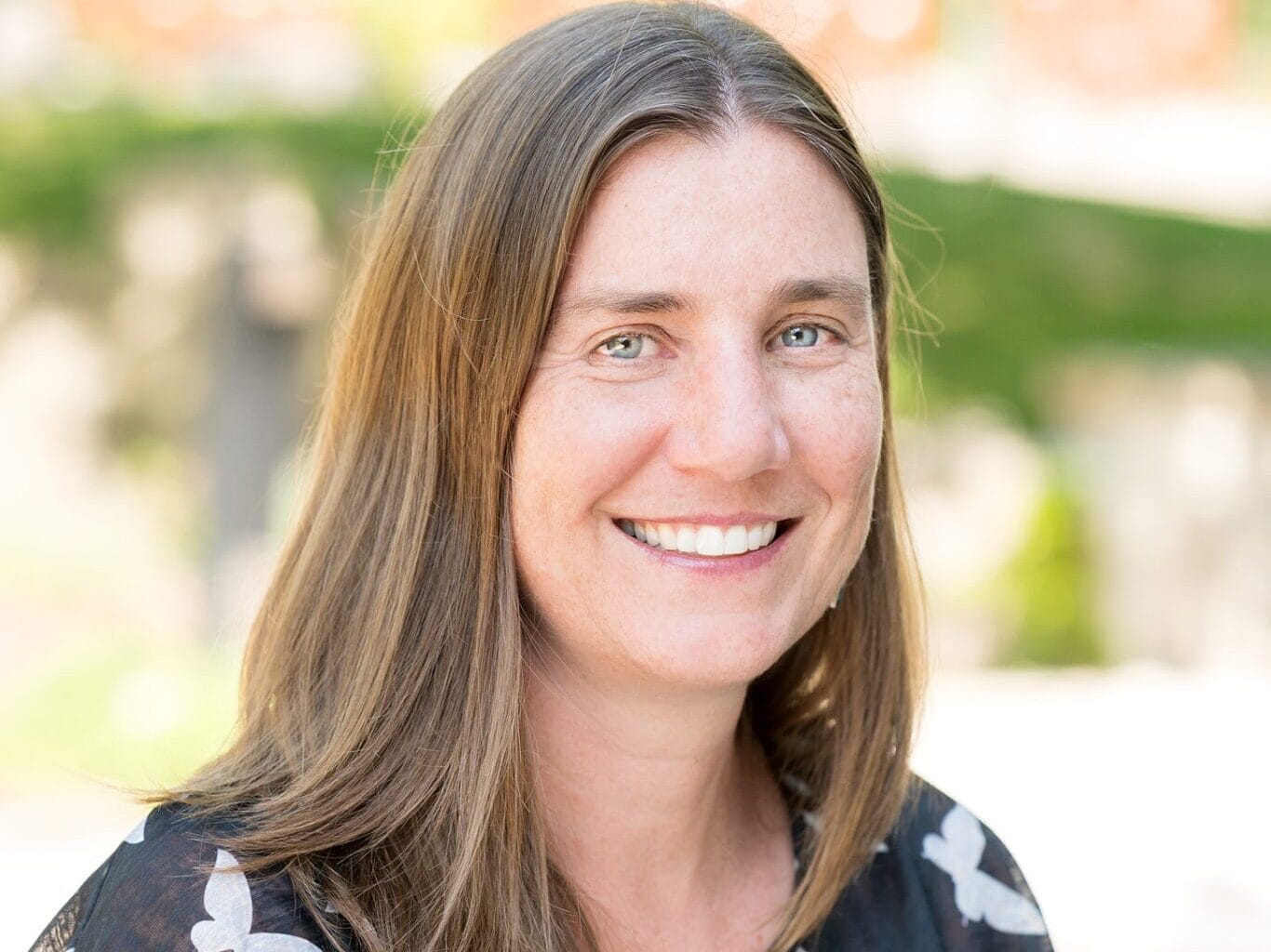 Ginny Cullen smiles in a relaxed outdoor setting