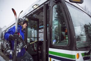 Man boarding Whistler Transit bus with skis