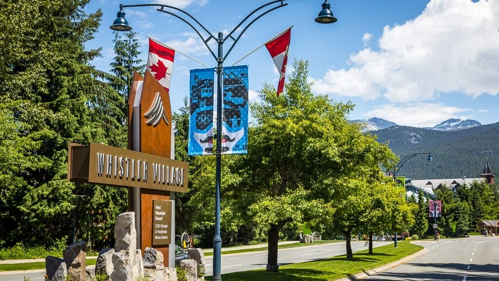 The entrance sign to Whistler Village on a summer day