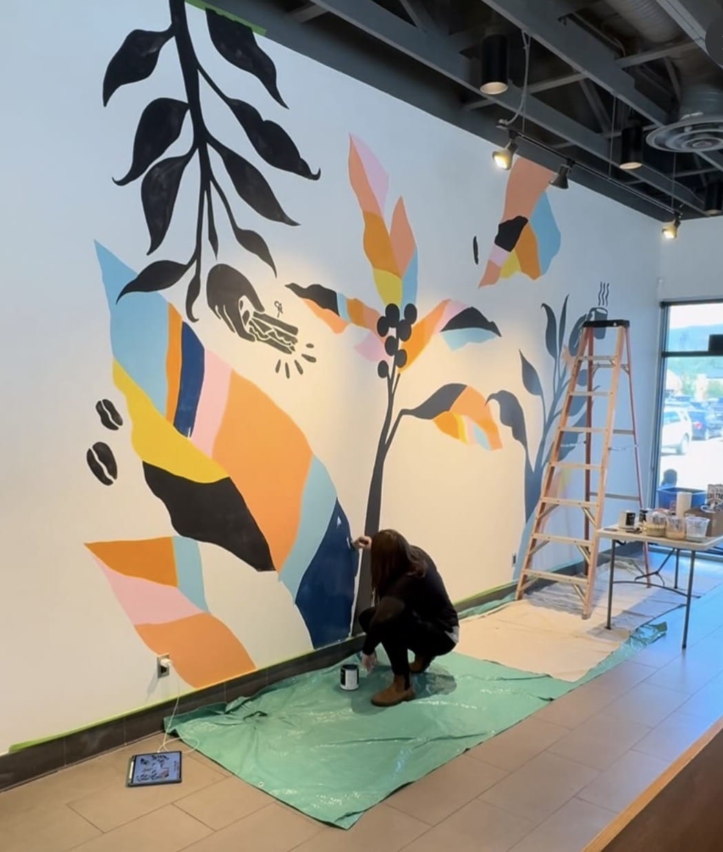 Artist Liz Dumontet painting a mural