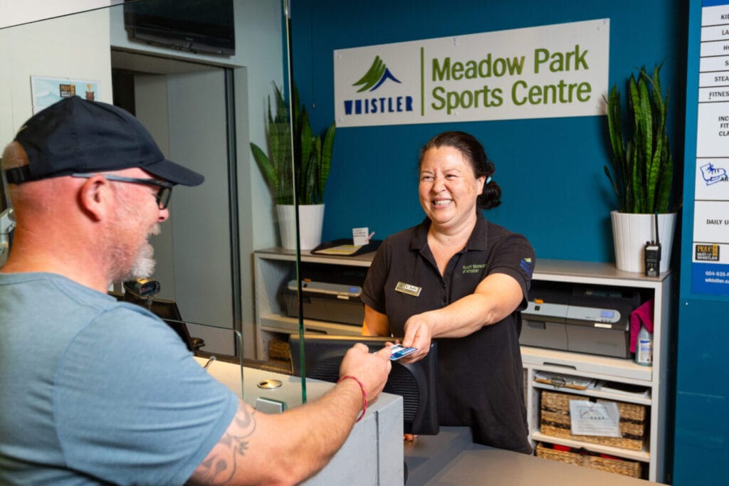 patron paying for recreation pass at reception
