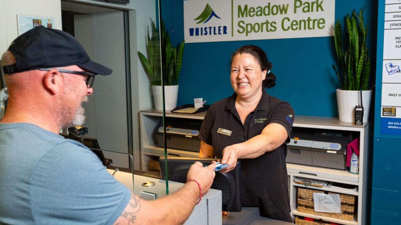 patron paying for recreation pass at reception