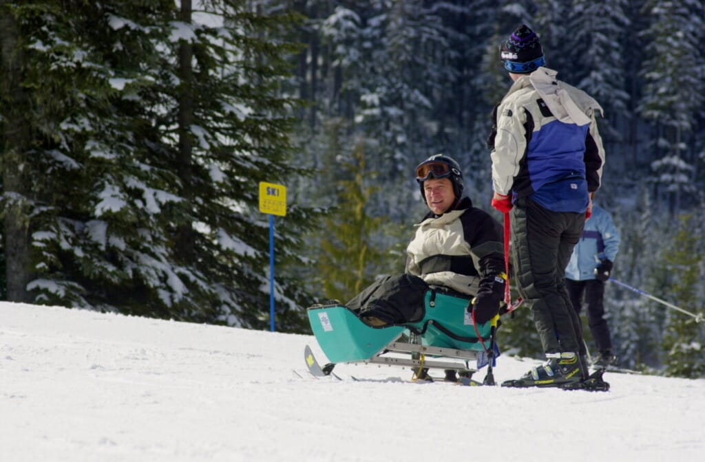 Rick Hansen sit skiing in Whistler