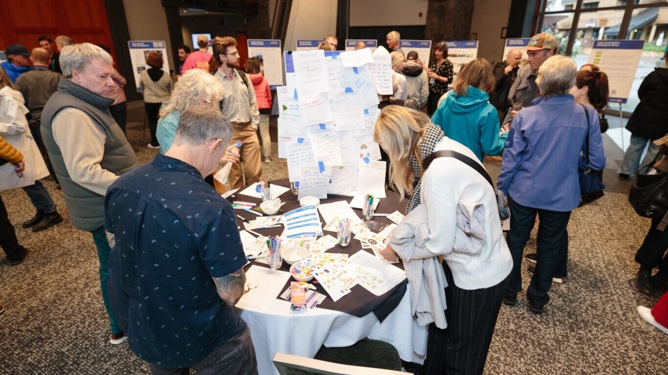 Community members writing post-it notes with feedback on how they want 4500 Northlands to be used