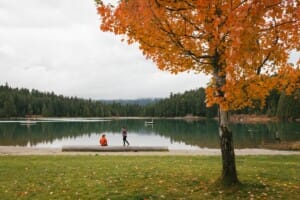 Couple hiking in the fall around Lost Lake in Whistler, British Columbia