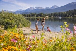 Family playing on the beach at Rainbow Park, Whistler