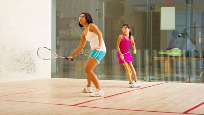 Two squash players rallying