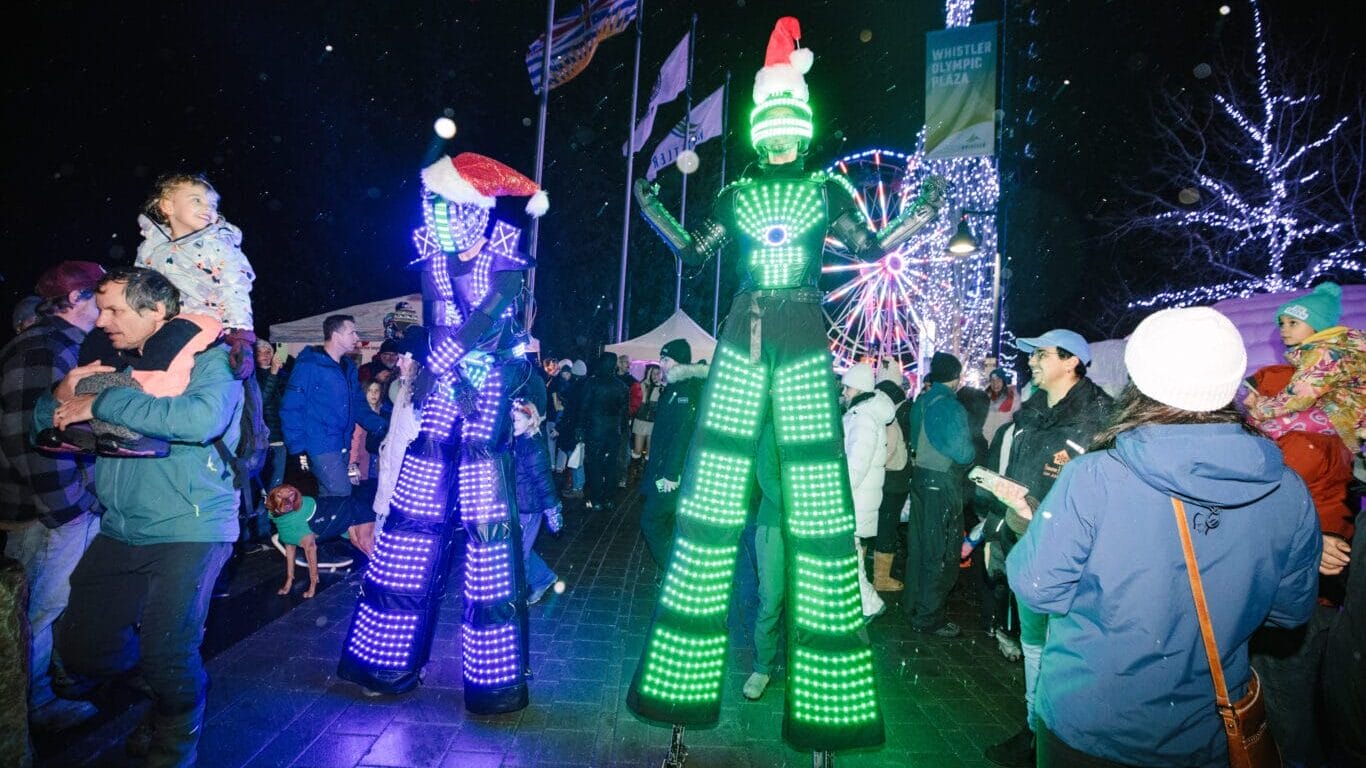 Lit up people on stilts at Winterlight